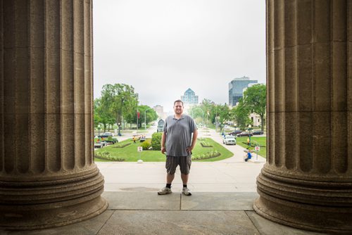 MIKAELA MACKENZIE / WINNIPEG FREE PRESS
Justin Luschinski, who is taking part in Pride this weekend, poses in front of the Manitoba Legislative Building in Winnipeg on Wednesday, May 30, 2018.  
Mikaela MacKenzie / Winnipeg Free Press 2018.