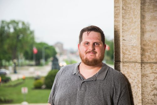 MIKAELA MACKENZIE / WINNIPEG FREE PRESS
Justin Luschinski, who is taking part in Pride this weekend, poses in front of the Manitoba Legislative Building in Winnipeg on Wednesday, May 30, 2018.  
Mikaela MacKenzie / Winnipeg Free Press 2018.