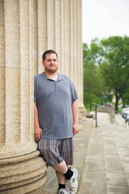 MIKAELA MACKENZIE / WINNIPEG FREE PRESS
Justin Luschinski, who is taking part in Pride this weekend, poses in front of the Manitoba Legislative Building in Winnipeg on Wednesday, May 30, 2018.  
Mikaela MacKenzie / Winnipeg Free Press 2018.