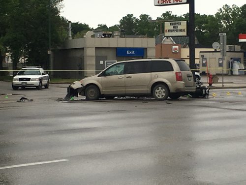 STACEY THIDRICKSON / WINNIPEG FREE PRESS
Police investigate a crash between a motorcycle and minivan at Portage Avenue near Home Street Saturday afternoon, June 2, 2018. The collision occurred around 2:15 pm.