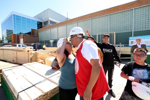 RUTH BONNEVILLE / WINNIPEG FREE PRESS


Kick-off for the Rady Faculty of Health Sciences & Habitat for Humanity Manitoba
??Build project.  

Craig Beaulieu partner, Leeann Dumas, share a kiss at the kick-off for building their own home at the build site in a parking lot near the Bannatyne Campus Monday.  The couple, alongside health professionals, researchers and students thanks to a continued partnership between the University of Manitobas Rady Faculty of Health Sciences and Habitat for Humanity Manitoba, will have their new home moved to Flora Ave. after the 10-day build blitz which is running June 4  15, 2018.

Their 4 kids, Eric (11yrs) left, Jordan (15yrs) rear,  Tierra (6yrs) and Quinton (14yrs) not seen in photo, were at the kick-off Monday with their parents who will be getting married next week.   
 

See Alex Paul Story. 
June 4,  2018
