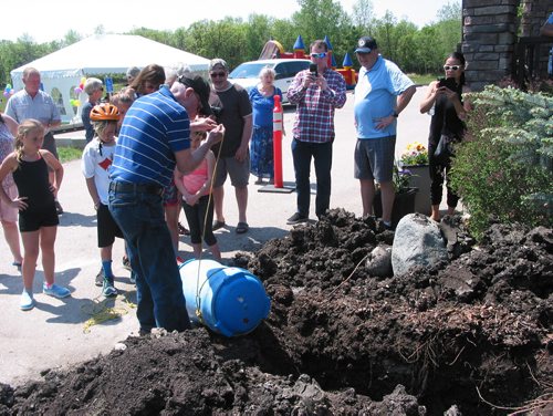 Canstar Community News May 26, 2018 - Tom Burns lowered the time capsule into the hole at Headingley Municipal Library. (ANDREA GEARY/CANSTAR COMMUNITY NEWS)