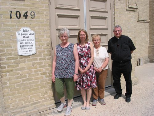 Canstar Community News May 23, 2018 - (From left) St. Francois Xavier Roman Cathoilc Church members Odile Thibert, Elaine Senecal and Lori Ann Regnier stand with parish priest Father Michel Nault outside the church. (ANDREA GEARY/CANSTAR COMMUNITY NEWS)