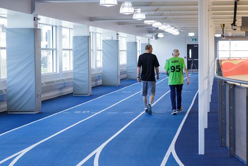 MIKE DEAL / WINNIPEG FREE PRESS
Lou Billinkoff warms up with his trainer Sheldon Reynolds (in black) before he runs the 50 meter dash, which he completed in 14.45 seconds on his 95th birthday at the Canada Games Sport for Life Centre while training for a 100m sprint at the end of June.
180605 - Tuesday, June 05, 2018.