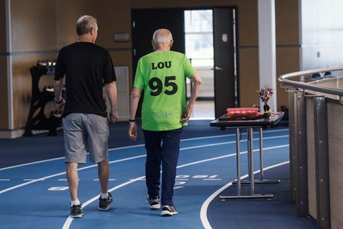 MIKE DEAL / WINNIPEG FREE PRESS
Lou Billinkoff warms up with his trainer Sheldon Reynolds (in black) before he runs the 50 meter dash, which he completed in 14.45 seconds on his 95th birthday at the Canada Games Sport for Life Centre while training for a 100m sprint at the end of June.
180605 - Tuesday, June 05, 2018.