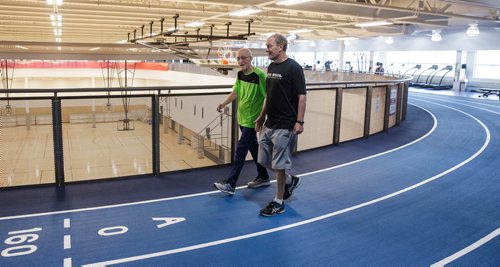 MIKE DEAL / WINNIPEG FREE PRESS
Lou Billinkoff warms up with his trainer Sheldon Reynolds (in black) before he runs the 50 meter dash, which he completed in 14.45 seconds on his 95th birthday at the Canada Games Sport for Life Centre while training for a 100m sprint at the end of June.
180605 - Tuesday, June 05, 2018.