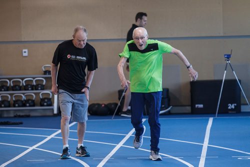 MIKE DEAL / WINNIPEG FREE PRESS
Lou Billinkoff warms up with his trainer Sheldon Reynolds (in black) before he runs the 50 meter dash, which he completed in 14.45 seconds on his 95th birthday at the Canada Games Sport for Life Centre while training for a 100m sprint at the end of June.
180605 - Tuesday, June 05, 2018.