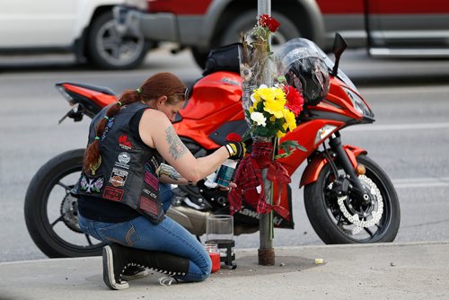 JOHN WOODS / WINNIPEG FREE PRESS
Tamara LeClair is comforted by family, friends and supporters gathered at the corner of Portage and Home Tuesday, June 5, 2018 to remember Benson, aka Matt Cave, who was killed in a motorcycle collision with a stolen van.