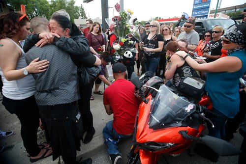 JOHN WOODS / WINNIPEG FREE PRESS
Robert Benson's son, left, is comforted by family, friends and supporters gathered at the corner of Portage and Home Tuesday, June 5, 2018 to remember Benson, aka Matt Cave, who was killed in a motorcycle collision with a stolen van.