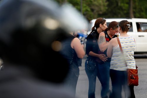 JOHN WOODS / WINNIPEG FREE PRESS
Tamara LeClair is comforted by family, friends and supporters gathered at the corner of Portage and Home Tuesday, June 5, 2018 to remember Benson, aka Matt Cave, who was killed in a motorcycle collision with a stolen van.