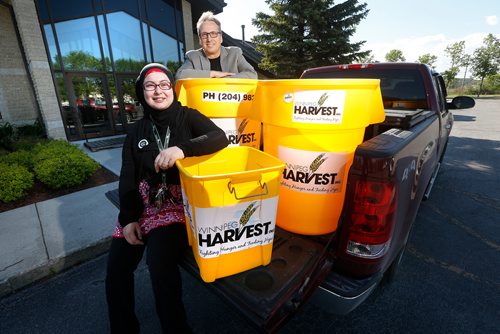 JOHN WOODS / WINNIPEG FREE PRESS
Lubna Usmari, Manitoba Islamic Association, and Rocky Baronins, Church of Jesus Christ of Latter Day Saints, are photographed with Winnipeg Harvest bins in preparation for their annual food drive Tuesday, June 5, 2018.