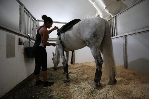 RUTH BONNEVILLE / WINNIPEG FREE PRESS

Cavalia Odysseo

Feature on Day in the life of a professional rider and her horse.  Photos shadowing  a Odysseo rider, Chelsea Jordan, and her horse Utah (brown) and other horses as they get ready for the show   prepping for the performance, makeup, hair, costume, rehearsals, pre-show rituals with rider/horse, some shots of show during water scene and  post-show wind down, shower, groom and treat time. 
Photos taken on May 31, 2018.
One of the grooms tightens the straps on a horse before the show. 

See Erin Lebar story
June 5,  2018
