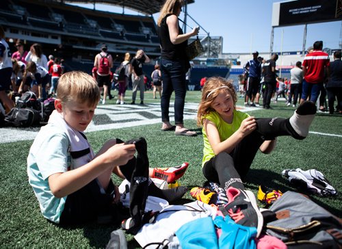 ANDREW RYAN / WINNIPEG FREE PRESS Carter and Brooklyn Deslandes strap on their soccer boots to play on the Investor's Group stadium field after the unveiling of Winnipeg's men's soccer team Valour FC. The team will play in the upcoming Canadian Premiere League, scheduled to start in 2019.