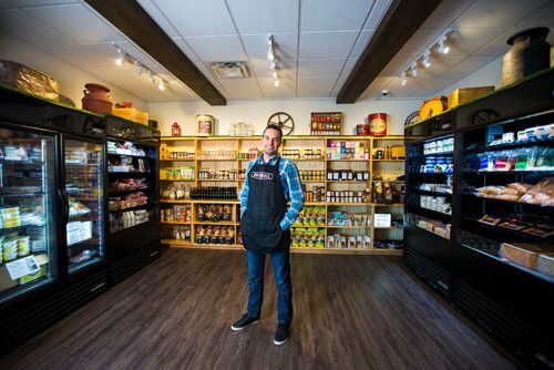 MIKAELA MACKENZIE / WINNIPEG FREE PRESS
Jean-Marc Champagne, co-owner of Fromagerie Bothwell, poses in the shop in Winnipeg on Wednesday, June 6, 2018. It's the first Bothwell shop in Winnipeg and besides cheese, it's stocked with all kinds of made-in-Manitoba products.
Mikaela MacKenzie / Winnipeg Free Press 2018.