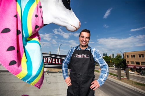 MIKAELA MACKENZIE / WINNIPEG FREE PRESS
Jean-Marc Champagne, co-owner of Fromagerie Bothwell, poses on the roof of the shop in Winnipeg on Wednesday, June 6, 2018. It's the first Bothwell shop in Winnipeg and besides cheese, it's stocked with all kinds of made-in-Manitoba products.
Mikaela MacKenzie / Winnipeg Free Press 2018.