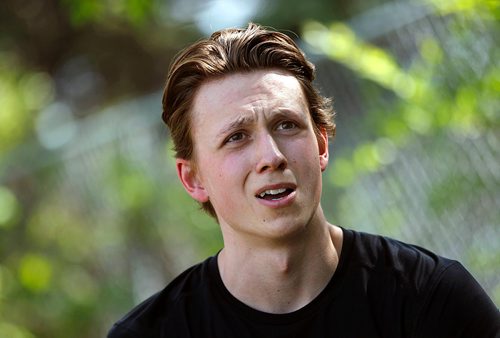 PHIL HOSSACK / WINNIPEG FREE PRESS -  Grade 12 student Josh Samyn speaks with Jason Bell between track and field events Thursday. See story. - June 7, 2018