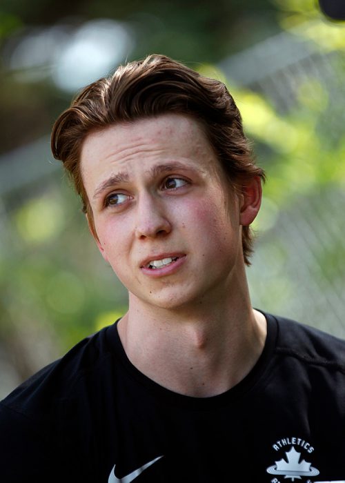 PHIL HOSSACK / WINNIPEG FREE PRESS -  Grade 12 student Josh Samyn speaks with Jason Bell between track and field events Thursday. See story. - June 7, 2018