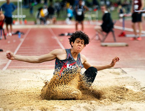 PHIL HOSSACK / WINNIPEG FREE PRESS - Kelvin Collegiate's decathlete Robin Brooks lands a long jump in competition Saturday afternoon. See Taylor Allen's story.- June 9, 2018