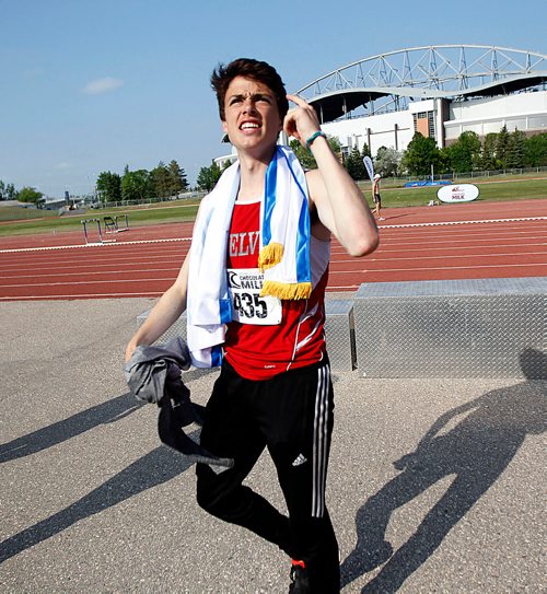 PHIL HOSSACK / WINNIPEG FREE PRESS - Kelvin Collegiate's Noel Kendle throws his teams championship banner over his shoulders and makes his way off the track after the award presentation Saturday afternoon. See Taylor Allen's story.- June 9, 2018