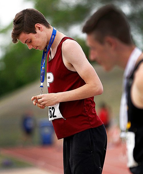 PHIL HOSSACK / WINNIPEG FREE PRESS - St Paul's Crusader and triple jump record breaker Robbie Gerstner checks out the hardware at a medal presentation Saturday afternoon. See Taylor Allen's story.- June 9, 2018