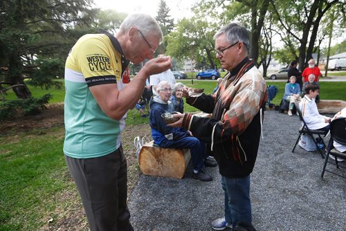 JOHN WOODS / WINNIPEG FREE PRESS
Anglican Bishop Robert Hardwick, who is cycling across Canada for healing and reconciliation with indigenous people, takes part in a smudge ceremony with Rev Canon Dr Murray Still, Chair of Rupertsland Indigenous Elders Circle, at the Truth and Reconciliation Healing Garden Monday, June 11, 2018.