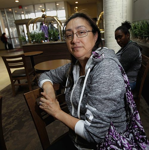 PHIL HOSSACK / WINNIPEG FREE PRESS - Doreen Keeper of Little Grand Rapids poses in the lobby at the HSC Canad Inns Hotel while waiting for her room to be prepared. Her three daughters were elsewhere. See Kevin Rollason's story.  - June 12, 2018