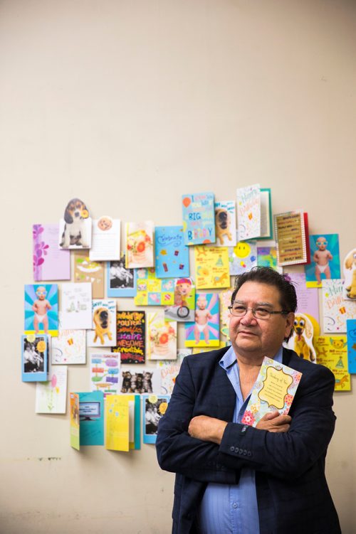 MIKAELA MACKENZIE / WINNIPEG FREE PRESS
Cross Lake councillor Donnie McKay poses in front of a sampling of hundreds of birthday cards for the health minister from people from Cross Lake who are yearning for provincial funds to help build a health complex while at the Manitoba Legislative Building in Winnipeg on Wednesday, June 13, 2018. 
Mikaela MacKenzie / Winnipeg Free Press 2018.