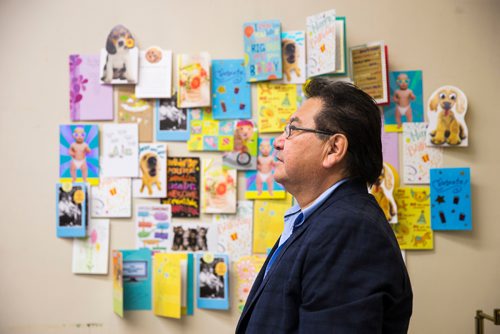 MIKAELA MACKENZIE / WINNIPEG FREE PRESS
Cross Lake councillor Donnie McKay poses in front of a sampling of hundreds of birthday cards for the health minister from people from Cross Lake who are yearning for provincial funds to help build a health complex while at the Manitoba Legislative Building in Winnipeg on Wednesday, June 13, 2018. 
Mikaela MacKenzie / Winnipeg Free Press 2018.