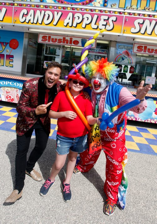 PHIL HOSSACK / WINNIPEG FREE PRESS -  DooDoo the clown aka Shane Farberman (right and his son Magician Aaron Matthews dres "Corn Carnie Faye Brewer in ballons at the Ex grounds Wednesday afternoon. Carnies are all old friends along this midway, DooDoo says he's knowm Faye all her life. Maggie Macintosh story. - June 13, 2018