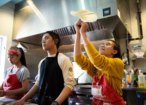 ANDREW RYAN / WINNIPEG FREE PRESS Neiliza Combate practices tossing pizza dough at the Food Justice club at the NorWest Co-op Community Health, lead by chef Camille Metcalf on June 13, 2018. The club is an after school program where students learn healthy eating habits and cooking basics.