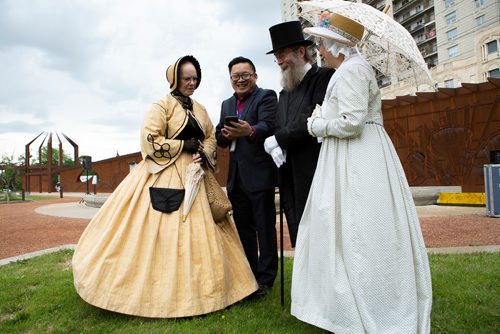 ANDREW RYAN / WINNIPEG FREE PRESS Keith Lim, demonstrates a new option for visitors to receive historical information in many different languages through an app was revealed at upper Fort Garry on June 14, 2018. From left is Judy McPherson, Keith Lim, Dr. James Sutherland, and May Sutherland, all from the Manitoba Living History Society.