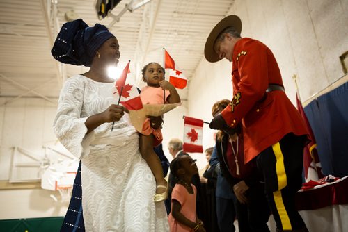 ANDREW RYAN / WINNIPEG FREE PRESS Immigration, Refugees and Citizenship Canada inducted new citizens in a special ceremony held at École Luxton School. Rafiat Sanni, and her daughter Basmah Lawal were one of the 38 immigrants who took the oath.