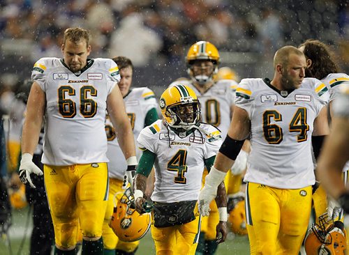 PHIL HOSSACK / WINNIPEG FREE PRESS -The Edmonton Oliers leave the field during a second weather delay Thursday at Investor's Group Field.   - June 14, 2018