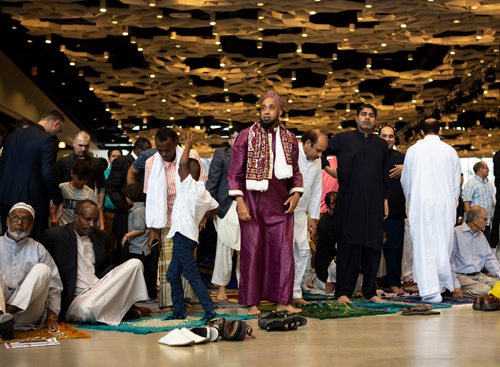 ANDREW RYAN / WINNIPEG FREE PRESS Ahmed Ashi, centre, and Muhammed Arfeen, right, prepare for morning prayers on Eid-ul-Fitr which marks the end of the month of Ramadan muslims in Winnipeg. Nearly 6,000 muslims gathered at the RBC Convention centre hall on June 15, 2018.