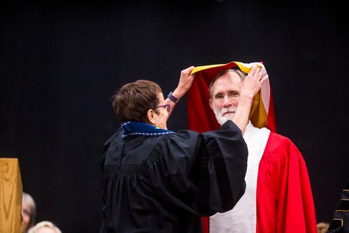 MIKAELA MACKENZIE / WINNIPEG FREE PRESS
Annette Trimbee gives Peter Agre an honorary doctor of science at the University of Winnipegs  2018 Spring Convocation ceremonies at the Duckworth Centre in Winnipeg on Friday, June 15, 2018. 
Mikaela MacKenzie / Winnipeg Free Press 2018.