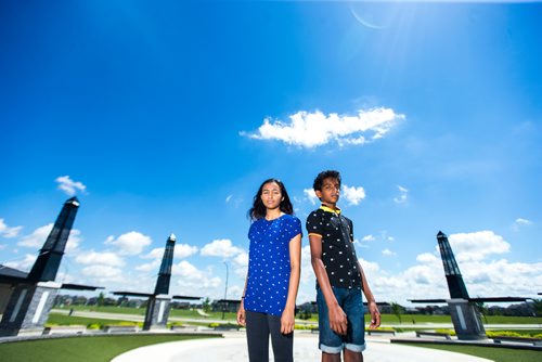 MIKAELA MACKENZIE / WINNIPEG FREE PRESS
Varsha (left) and Varun Subramanian pose in front of the dry splash pad in the Bridgwater Lakes neighbourhood in Winnipeg on Friday, June 15, 2018. 
Mikaela MacKenzie / Winnipeg Free Press 2018.