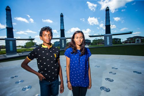 MIKAELA MACKENZIE / WINNIPEG FREE PRESS
Varun (left) and Varsha Subramanian pose in front of the dry splash pad in the Bridgwater Lakes neighbourhood in Winnipeg on Friday, June 15, 2018. 
Mikaela MacKenzie / Winnipeg Free Press 2018.