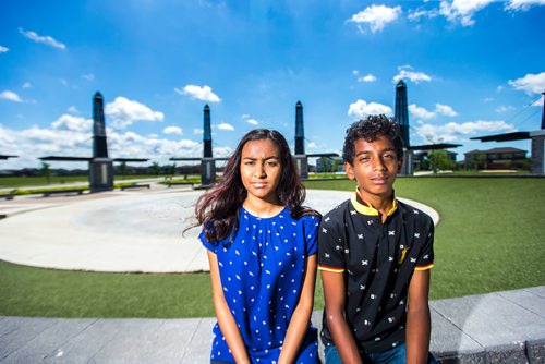 MIKAELA MACKENZIE / WINNIPEG FREE PRESS
Varsha (left) and Varun Subramanian pose in front of the dry splash pad in the Bridgwater Lakes neighbourhood in Winnipeg on Friday, June 15, 2018. 
Mikaela MacKenzie / Winnipeg Free Press 2018.