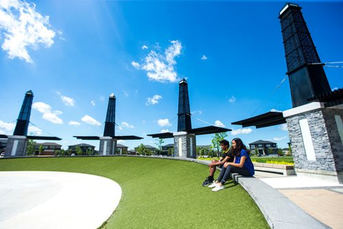 MIKAELA MACKENZIE / WINNIPEG FREE PRESS
Varun (left) and Varsha Subramanian pose in front of the dry splash pad in the Bridgwater Lakes neighbourhood in Winnipeg on Friday, June 15, 2018. 
Mikaela MacKenzie / Winnipeg Free Press 2018.