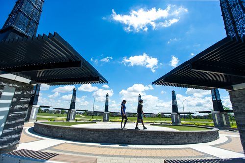 MIKAELA MACKENZIE / WINNIPEG FREE PRESS
Varsha (left) and Varun Subramanian pose in front of the dry splash pad in the Bridgwater Lakes neighbourhood in Winnipeg on Friday, June 15, 2018. 
Mikaela MacKenzie / Winnipeg Free Press 2018.