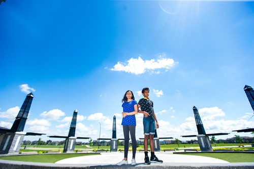 MIKAELA MACKENZIE / WINNIPEG FREE PRESS
Varsha (left) and Varun Subramanian pose in front of the dry splash pad in the Bridgwater Lakes neighbourhood in Winnipeg on Friday, June 15, 2018. 
Mikaela MacKenzie / Winnipeg Free Press 2018.