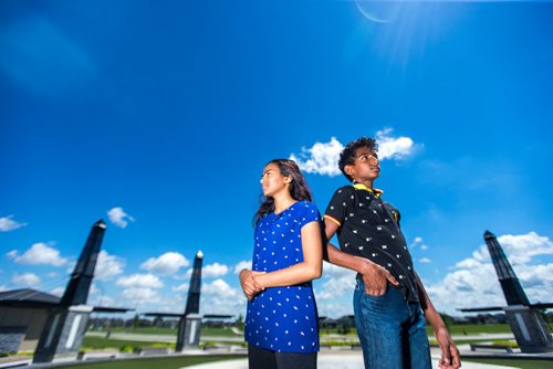 MIKAELA MACKENZIE / WINNIPEG FREE PRESS
Varsha (left) and Varun Subramanian pose in front of the dry splash pad in the Bridgwater Lakes neighbourhood in Winnipeg on Friday, June 15, 2018. 
Mikaela MacKenzie / Winnipeg Free Press 2018.