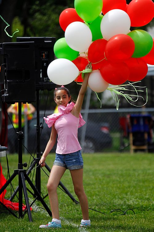 PHIL HOSSACK / WINNIPEG FREE PRESS - STAND-UP - 11 yr old Aya Hasan hands out ballons at the annual Welcome Fair for Canadian newcomers Saturday morning at the Freight House grounds on Isabel St. The former SYrian has only been in Canada with her family for a year. See release/story?- June 16, 2018