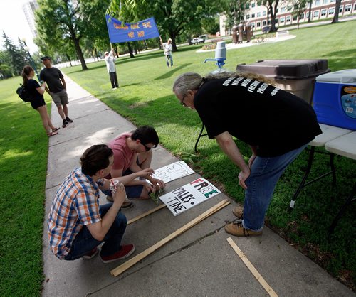PHIL HOSSACK / WINNIPEG FREE PRESS - STAND-UP - Members of the Peace Alliance Winnipeg prep pickets and signs for their annual Peace March at the Legislature Saturday morning. Marchers were to head south through Osborne Village then back to the legislature starting at noon. See release?- June 16, 2018