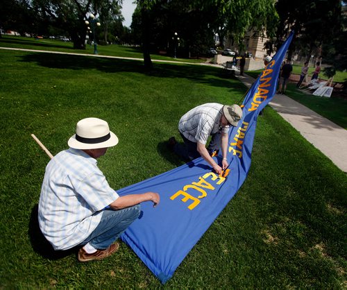 PHIL HOSSACK / WINNIPEG FREE PRESS - STAND-UP - "P" is for Peace! Peace Marchers prep a banner by pinning the letter "P" in peace on a large banner Saturday morning. Members of the Peace Alliance Winnipeg prep pickets and signs for their annual Peace March at the Legislature Saturday morning. Marchers were to head south through Osborne Village then back to the legislature starting at noon. See release?- June 16, 2018