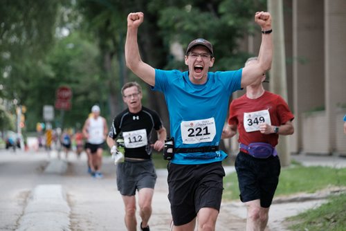 Daniel Crump / Winnipeg Free Press. Nicholas Pasieczka, 17, pumps his hands in the air during a milestone adventure in his life. He went on to finish first place in the youth male category in the full marathon. The 40th Manitoba Marathon, Sunday, June 17, 2018.