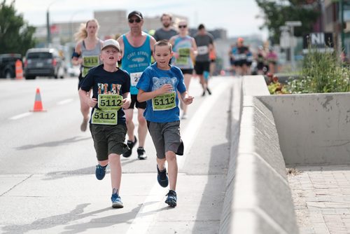 Daniel Crump / Winnipeg Free Press. Two members from Team Cormier from La Salle,MB make their way over the Norwood Bridge. The 40th Manitoba Marathon, Sunday, June 17, 2018.
