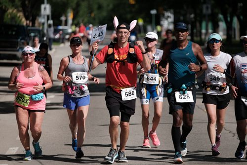 Daniel Crump / Winnipeg Free Press. Pace bunny Curtis Tyndall (580) leads the way for some of the marathon participants at the 40th Manitoba Marathon, Sunday, June 17, 2018.