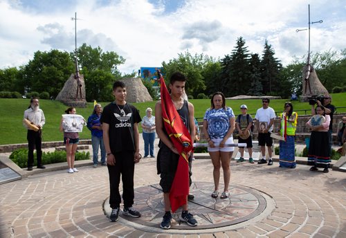 ANDREW RYAN / WINNIPEG FREE PRESS Josiah Pratt, left, and brother Rane, centre, stand with Gina Settee during a gathering at The Forks raising awareness of the missing and murdered indigenous men on June 17, 2018.