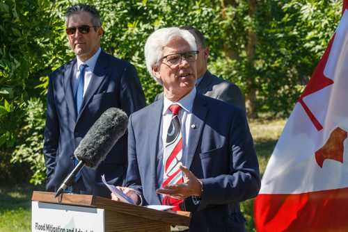 MIKE DEAL / WINNIPEG FREE PRESS
MP Jim Carr talks during the announcement with 
Premier Brian Pallister for a $540 million infrastructure project for flood management of the Lake Manitoba and Lake St. Martin outlet channels at an event at Parc Gros Arbre, off Allard Road close to St. Laurent, Manitoba, Monday morning.

180618 - Monday, June 18, 2018.